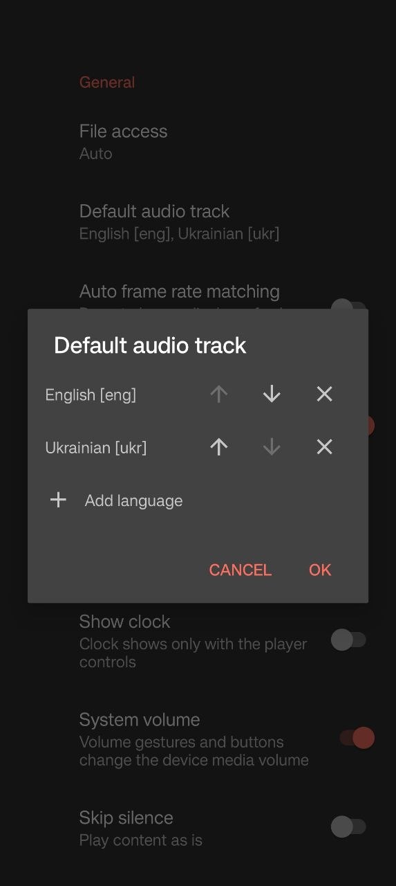 The Default audio track dialog in Settings, listing English [eng] above Ukrainian [ukr], each with arrows to move it up or down and an X to remove it, over an Add language row.