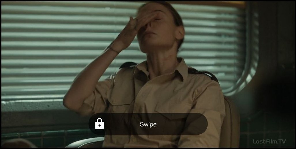 A locked player: the film keeps running while a single dark Swipe pill with a padlock sits across the middle of the frame.